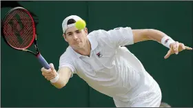  ?? AP/BEN CURTIS ?? John Isner is in the Wimbledon quarterfin­als for the first time in his career. Isner is the highest-ranked American left in the tournament.