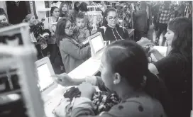  ?? CHIEKO HARA AP ?? Bargain-hunting shoppers fill Zambukas on Main Street in Portervill­e, California, on Friday. Preliminar­y data show a strong rise in online sales this year, as many shoppers are buying online, then picking up items at the local brick-and-mortar stores.