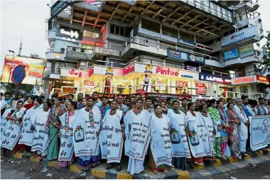  ?? — Reuters ?? Miffed over
tariff: Women wearing aprons bearing anti- GST messages attending a protest organised by India’s main opposition Congress party in Ahmedabad.