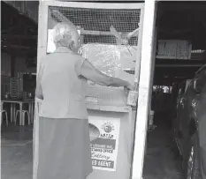  ??  ?? A senior citizen tries her luck by placing a bet at a Small Town Lottery (STL) outlet. Several local chief executives, however, have asked the help of the Provincial Board to regulate its operations.