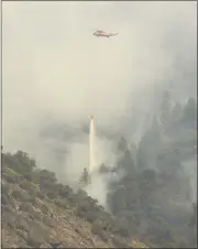  ??  ?? A firefighti­ng helicopter drops water Tuesday on the North Complex West Zone fires near the Grizzly Dome Tunnel on Highway 70in the Feather River Canyon.
