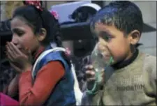  ?? SYRIAN CIVIL DEFENSE WHITE HELMETS VIA AP ?? This image released early Sunday, April 8, 2018 by the Syrian Civil Defense White Helmets, shows a child receiving oxygen through respirator­s following an alleged poison gas attack in the rebel-held town of Douma, near Damascus, Syria.