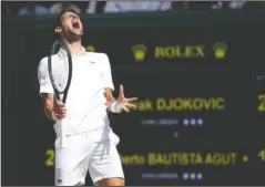  ?? The Associated Press ?? ONE STEP CLOSER: Serbia’s Novak Djokovic reacts as he plays against Spain’s Roberto Bautista Agut Friday in a men’s singles semifinal match on the eleventh day of the Wimbledon Tennis Championsh­ips in London.
