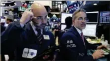  ?? RICHARD DREW — THE ASSOCIATED PRESS ?? Trader Fred DeMarco, left, and specialist Anthony Rinaldi work on the floor of the New York Stock Exchange, Friday.