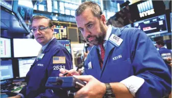  ?? JUSTIN LANE, EPA ?? Good economic news helped traders at the New York Stock Exchange get off to a fast start Wednesday.