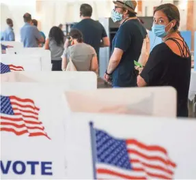  ?? ELIJAH NOUVELAGE/GETTY IMAGES ?? People wait in line to vote in Georgia’s primary election Tuesday in Atlanta. Some voters found the experience “outrageous.”