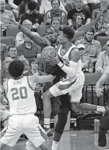  ?? Michael Thomas / Associated Press ?? Texas’ Kerwin Roach runs into Kansas State’s Makol Mawien in the second half, when Roach was held to three of his 17 points.