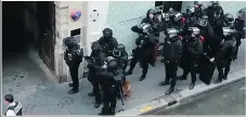  ?? —AP ?? Police in riot gear surround the entrance of a building in Paris where a man is believed to be holding hostages.