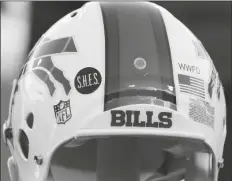  ?? ASSOCIATED PRESS ?? THIS DEC. 30, 2012, file photo shows a Buffalo Bills helmet displaying a WWFD (West Webster Fire Department) decal in memory of two fallen West Webster, N.Y., firefighte­rs who lost their lives in a shooting and a S.H.E.S. decal in honor of the victims of the Sandy Hook Elementary School shootings, before an NFL football game against the New York Jets in Orchard Park, N.Y.