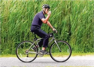  ?? SUSAN WALSH / AP ?? President Joe Biden bikes in Rehoboth Beach, Delaware, June 3.