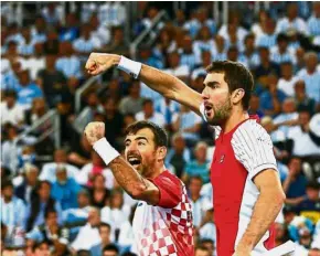  ??  ?? Triumphant: Croatia’s Marin Cilic (right) and Ivan Dodig celebrate after winning the doubles match against Argentina’s Leonardo Mayer and Juan Martin del Potro in the Davis Cup final on Saturday. — Reuters