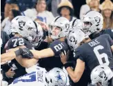  ?? RON JENKINS/AP ?? Raiders kicker Daniel Carlson (2) is congratula­ted by teammates after his game-winning field goal against the Cowboys in OT Thursday in Arlington, Texas.