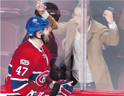  ?? RYAN REMIORZ/THE CANADIAN PRESS ?? An excited fan joins Canadiens forward Alexander Radulov in celebratin­g his third period goal Tuesday night.