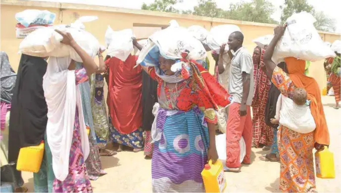  ??  ?? Women from various Maiduguri IDP camps receiving relief packages directly from Mohammadu Indimi Foundation