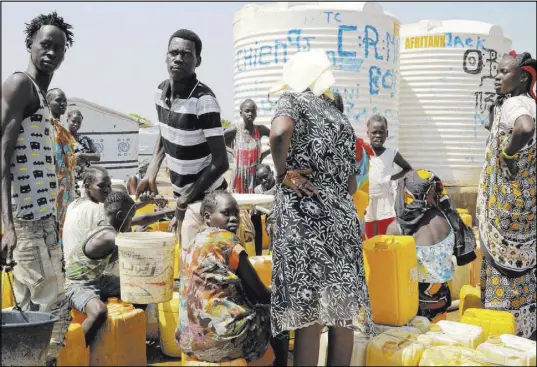  ?? Sam Mednick The Associated Press ?? Residents line up for water Tuesday at the Mangateen camp for the internally displaced on the outskirts of Juba, South Sudan.