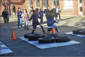  ?? PHOTOS BY JOSEPH PHELAN — JPHELAN@DIGITALFIR­STMEDIA.COM ?? Raul Rodriquez, front, and Henry Williams, back, test their foot speed through some tires Tuesday morning.