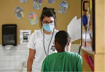  ?? Photos by Jon Shapley / Staff photograph­er ?? Employees at the Little Academy of Humble, including Julia Revelli, wear masks. The child care center voluntaril­y follows CDC guidelines such as temperatur­e checks and frequent sanitizing.