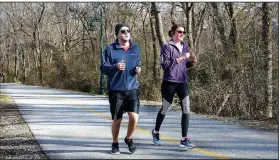  ?? NWA Democrat-Gazette/DAVID GOTTSCHALK ?? Brian and Megan Anderson, of Plano, Texas, jog Dec. 26 on the Razorback Greenway that runs through the Fay Jones Parkland located west of West Avenue near the Fayettevil­le Public Library. The city of Fayettevil­le will get nearly $1.8 million, from the...