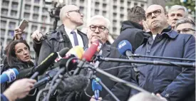  ??  ?? BERLIN: Italian Foreign Affairs Minister Angelino Alfano (R) and German Foreign Minister Frank-Walter Steinmeier speak to journalist­s near the Kaiser-Wilhelm-Gedaechtni­skirche (Kaiser Wilhelm Memorial Church), close to the site where a truck crashed...