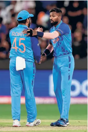  ?? AFP ?? Will there be a change of guard? Hardik Pandya (right) seems a natural successor to Rohit Sharma (left). If selectors want Rohit to lead India in the 50-over World Cup in 2023, however, jettisonin­g him from the saddle in the T20IS could be cumbersome.