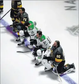  ?? Jason Franson The Associated Press ?? Knights players Ryan Reaves (75) and Robin Lehner (90) are joined by the Dallas Stars’ Jason Dickinson (18) and Tyler Seguin (91) in taking a knee Monday.