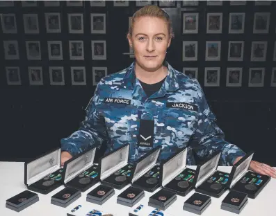  ??  ?? Leading Aircraftwo­man Kristie Jackson with some of the medals she has helped distribute.