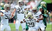  ?? / AP-Jason Behnken ?? Jackets defensive back Tariq Carpenter (29) celebrates after intercepti­ng a pass from Bulls quarterbac­k Blake Barnett (11) during the first quarter of an NCAA game in Tampa, Fla., on Saturday.