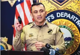  ?? ADOLPHE PIERRE-LOUIS/JOURNAL ?? Bernalillo County Sheriff Manuel Gonzales holds up a Bluetooth device deputies use to turn on their on-body camera.