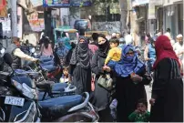  ?? — AFP ?? Muslim women make their way through a busy market area near the Jama Masjid Rampur in India’s Uttar Pradesh state.