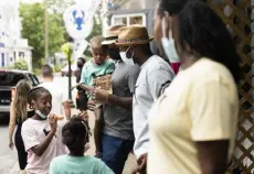  ?? Lauren Justice, © The New York Times Co. ?? Jackson and Thompson family members socialize outside C’est La Vie, a Black-owned apparel store in Oak Bluffs, Mass., on Aug. 29.