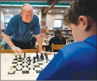  ?? (AP/Robert F. Bukaty) ?? Custodian and chess coach David Bishop challenges sixth-grader Owen Isenhour on April 25 during after-school practice in Hampden, Maine. Under Bishop’s tutelage, the Reeds Brook Middle School chess team has gained national recognitio­n.