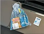 ??  ?? Snacks and cleaning supplies are given to passengers.