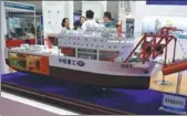  ?? WU CHANGQING / FOR CHINA DAILY ?? An offshore nuclear power station model on display at an industry expo in Beijing.