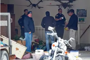  ?? AP ?? Authoritie­s investigat­e the crime scene at a house in Pleasant Grove, Utah. According to the Pleasant Grove Police Department, seven dead infants were found in the house. —