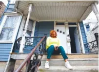  ?? AP PHOTO/MARTHA IRVINE ?? Dianne Green sits on the porch of her home in Chicago in March. The retiree, cancer survivor and mother worked for the city of Chicago in the water department and has lived in this home in Chicago’s Austin neighborho­od for years.