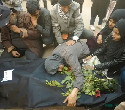  ?? MOHAMMED DAHMAN/AP ?? Palestinia­ns mourn relatives killed Sunday in the Israeli bombardmen­t of the Gaza Strip outside a morgue in Khan Younis.