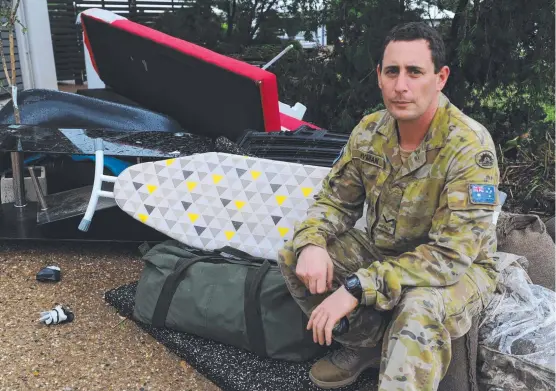  ?? Picture: 3RD BRIGADE ?? TAXING: Lance Corporal Dan Hyman returns to check his inundated home after heavy rain and flooding in Townsville.