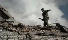  ?? Photograph: Global Images Ukraine/Getty Images ?? A rescuer finishes extinguish­ing a fire at the site of a Russian strike on a residentia­l building in Kharkiv.