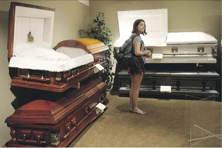  ?? DAVID BLOOM ?? Nancy Kenny looks at caskets at an open house at the South Side Memorial Chapel Tuesday. Kenny’s Fringe Festival play, Everybody Dies In December, takes place in a mortuary.