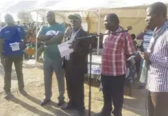  ??  ?? Former Nangoma UPND chairman Langson Nakamamba (in cap) PF Chitambo MP Chanda Mutale as he received defectors