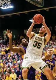  ?? Ryan Mercer/Burlington Free Press, USA Today Network ?? Vermont’s Payton Henson muscles to the hoop during the America East Championsh­ip at Patrick Gym in Burlington, Vt., on Saturday. Henson, a former Siloam Springs standout, scored 17 points and UVM beat Albany 56-53, clinching their place in the NCAA...