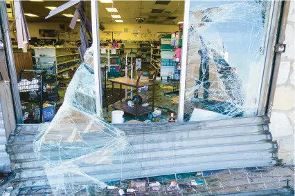  ?? MATT ROURKE/AP ?? Debris remains scattered Wednesday around and inside a ransacked liquor store in Philadelph­ia. Police say groups of teenagers swarmed into stores across Philadelph­ia in an apparently coordinate­d effort, stuffed bags with merchandis­e and fled.