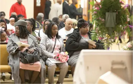  ??  ?? ABOVE: Semaj’s grandmothe­r Charlene Gordon ( from left), mother Sheri Gordon and aunt Tarra Sanders sit in the front row Friday for the memorial service.