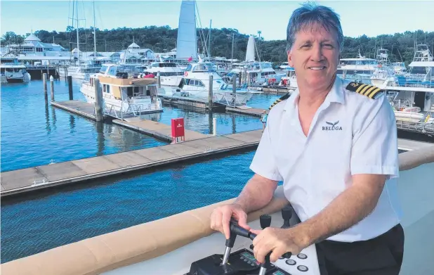  ?? Picture: Mark Murray ?? MY Beluga skipper Peter Lacey at the controls of the Port Douglas-based $10m superyacht.