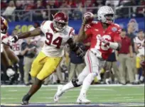  ?? LM OTERO — ASSOCIATED PRESS ?? Ohio State quarterbac­k J.T. Barrett is chased by USC defensive tackle Rasheem Green during the first half of the Cotton Bowl on Dec. 29 in Arlington, Texas.