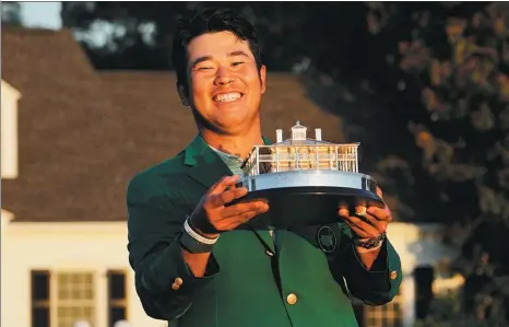  ?? AP ?? Hideki Matsuyama proudly holds the Masters trophy after his historic victory at Augusta National in Georgia on Sunday. The 29-year-old Japanese is the first Asian winner of the tournament, and just the second male golfer from the continent to capture a major.