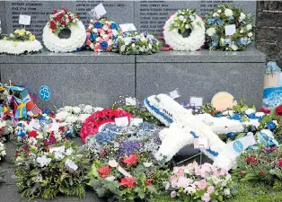  ??  ?? Floral tributes including one in the shape of doomed plane at Dryfesdale Cemetery