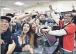  ?? AP PHOTO ?? 7-Eleven store clerk M. Faroqui celebrates with customers after learning the store sold a winning Powerball ticket in Chino Hills, Calif.