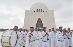  ?? AFP, AP ?? Pakistan Navy band members perform during a ceremony at the mausoleum of Pakistan’s founder Quaid-e-Azam Mohammed Ali Jinnah to mark the country’s Independen­ce Day in Karachi on Monday; and, right, people from the Sikh community celebrate the day in...