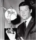  ??  ?? This is a July 8, 1968 file photo of British actor Roger Moore as he poses with Spain's most prized award, the Don Quixote Award, which was presented to him at the Spanish Embassy in London.